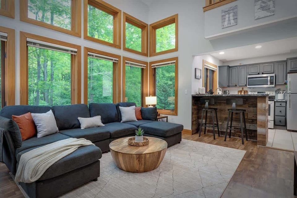 Great room with fireplace, HD TV and vaulted ceilings adjoining the kitchen