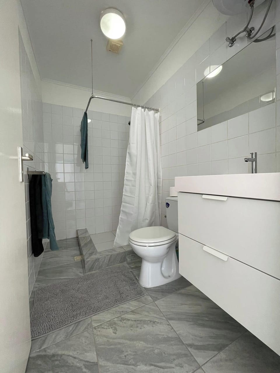 Bathroom with new water heater and walk in shower.