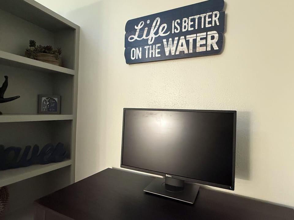 Got work? The workspace is equipped with a desk, monitor, and ergonomic chair. 