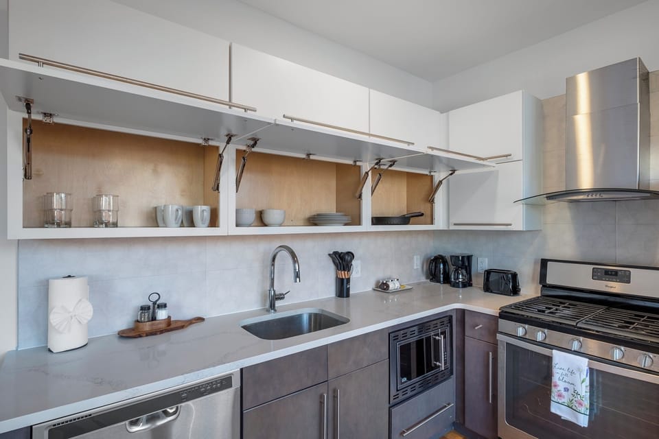 Stylish two-tone cabinetry with quartz breakfast bar for casual dining.