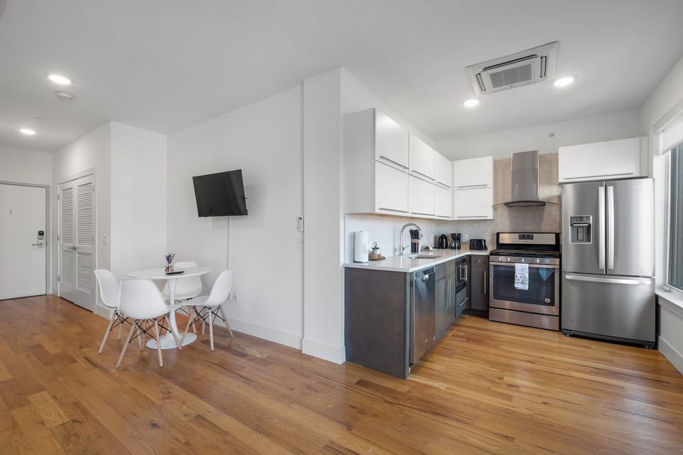 Modern kitchen with ample cabinet storage and quality appliances, and a befittng dining area to compliment.