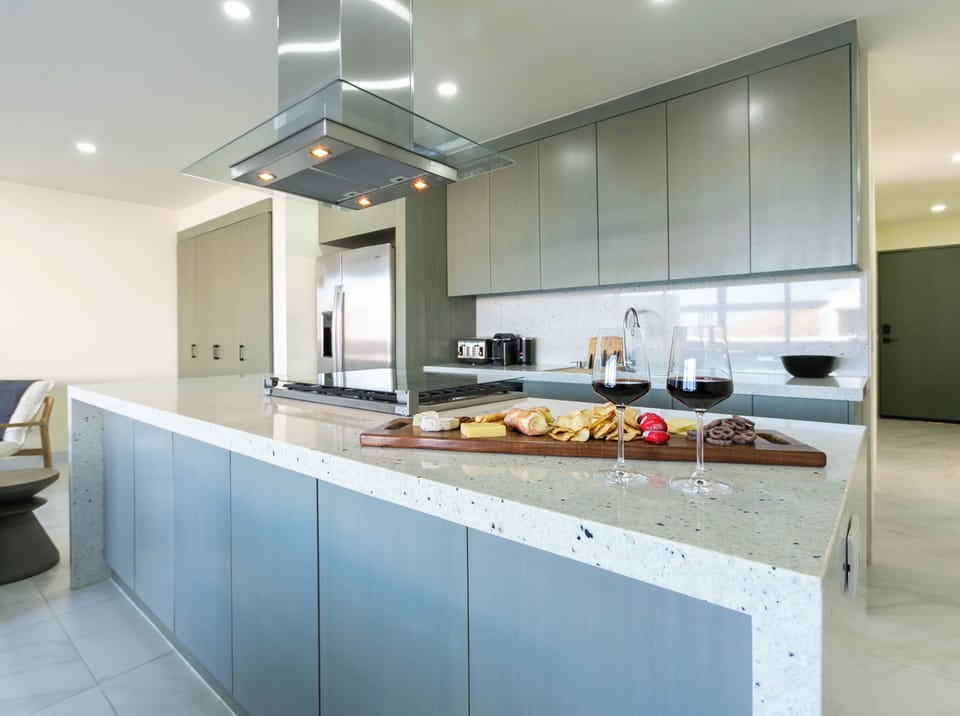 Fully equipped open-concept kitchen with all the essentials, including modern appliances, cookware, and utensils, making it easy to prepare meals and enjoy home-cooked comfort.