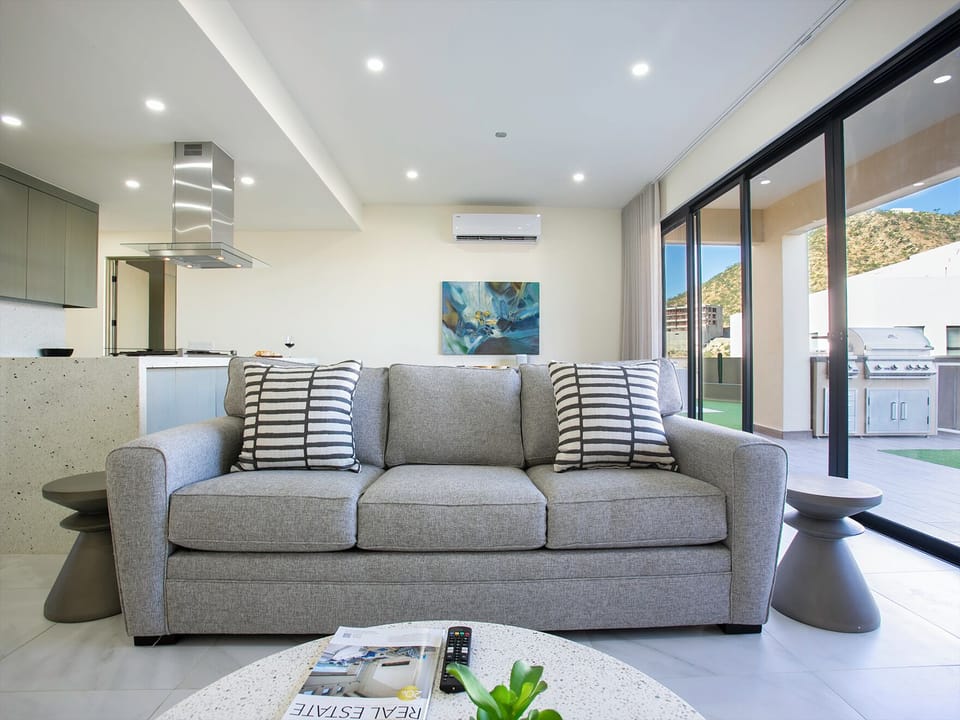 Inviting living area with a comfortable pull-out sofa, perfect for extra sleeping space or a cozy spot to relax and unwind.