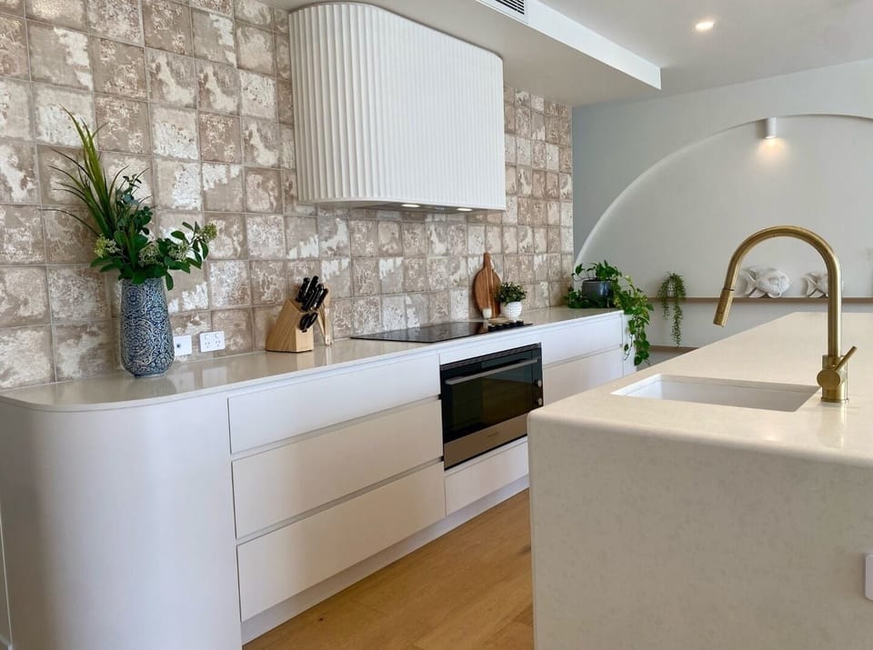 Kitchen with 90cm electric stove and oven.