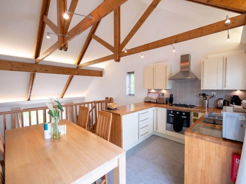 Large, open plan kitchen and dining space with balcony