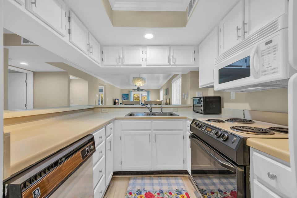 Stocked kitchen complete with cookware, dishes, and all necessary amenities. 