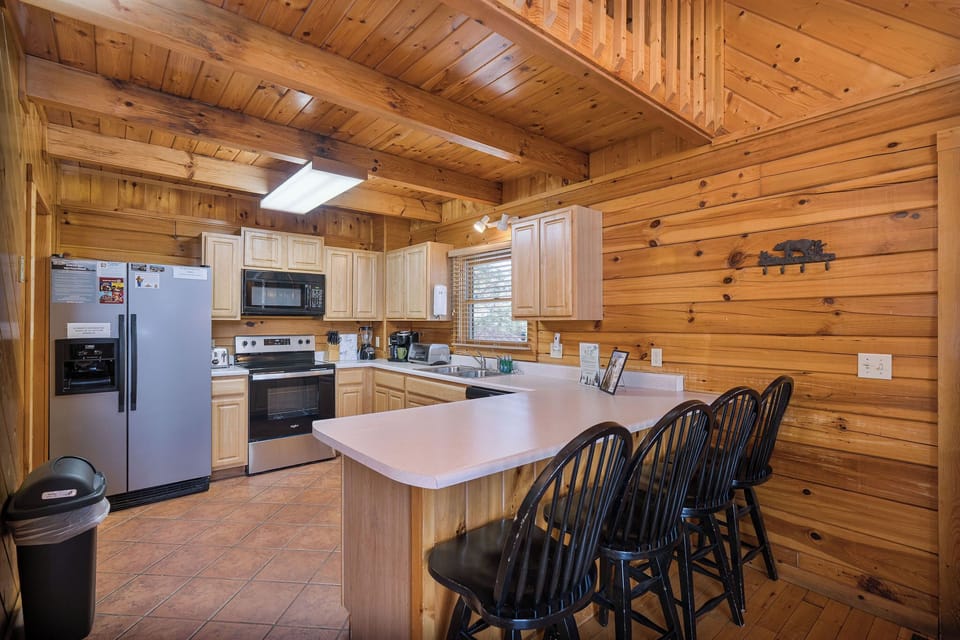 full kitchen with counter and chairs