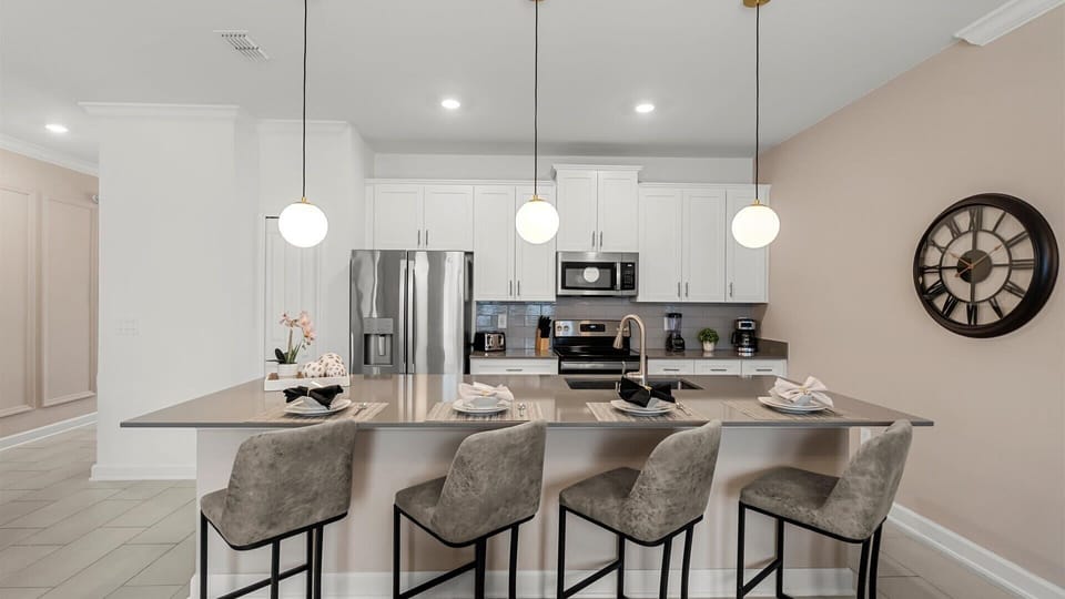 Fully equipped modern chef's kitchen with breakfast bar seating