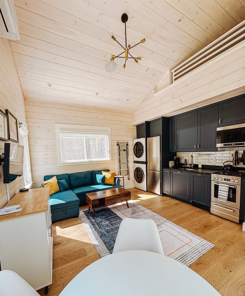 View of kitchen and living area. Couch pulls out to a full size sleeping area.