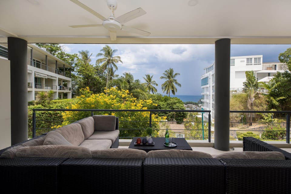 Large balcony with L shaped sofa and views over the Andaman Sea