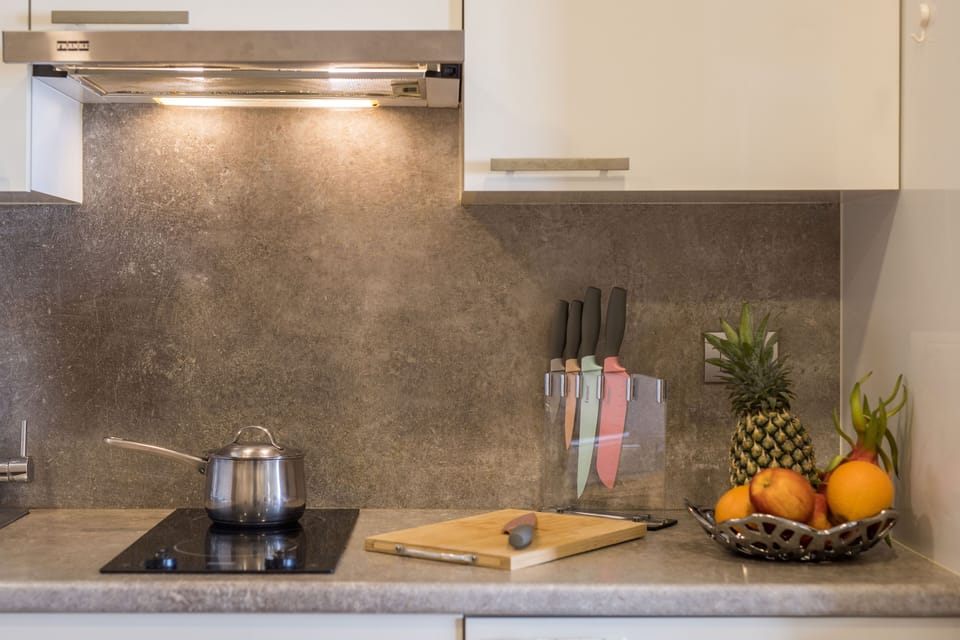 Kitchen with stove and extractor hood