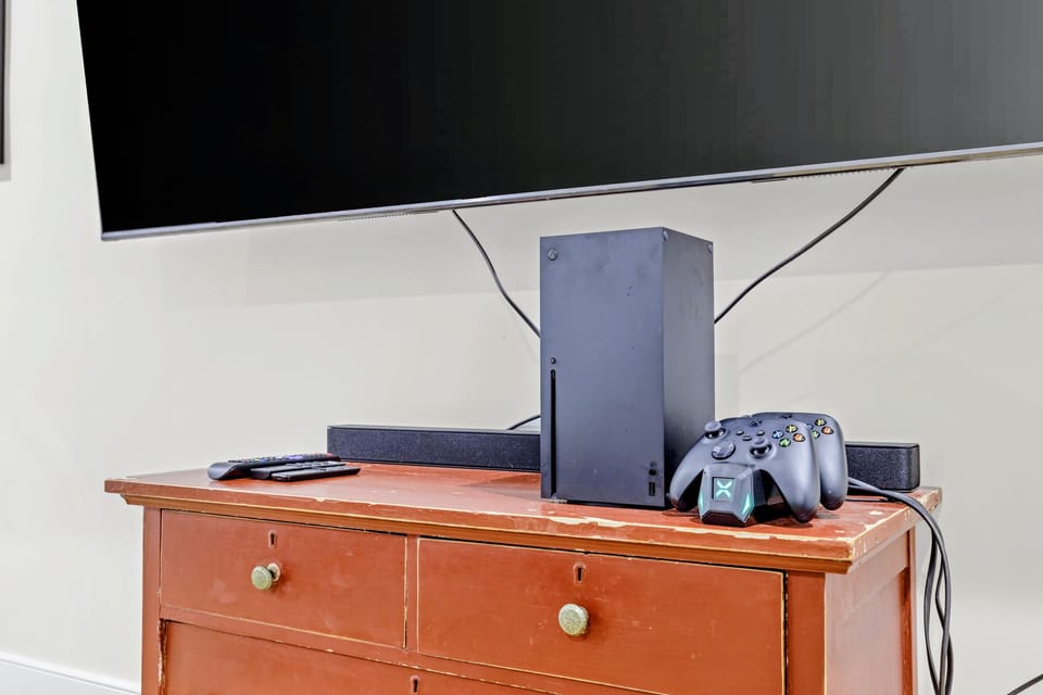 Theater - The big screen, soundbar, and Xbox Series X set up on the rustic media cabinet, ready for movies or games.