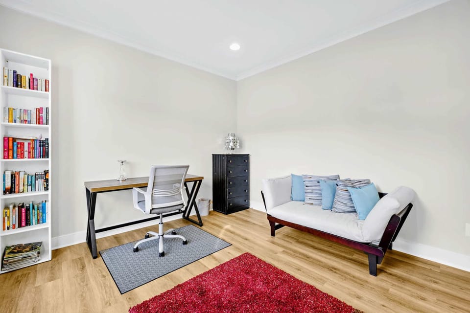 Office - Tall bookshelves of color-coded paperbacks set the mood beside the writing desk and a cushioned futon.