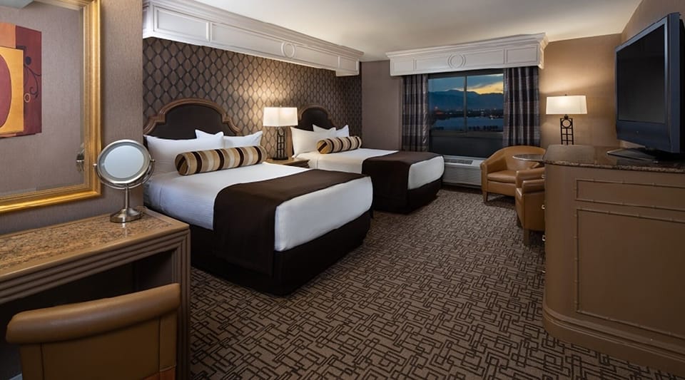 Wake up to cozy double beds and a scenic window view.