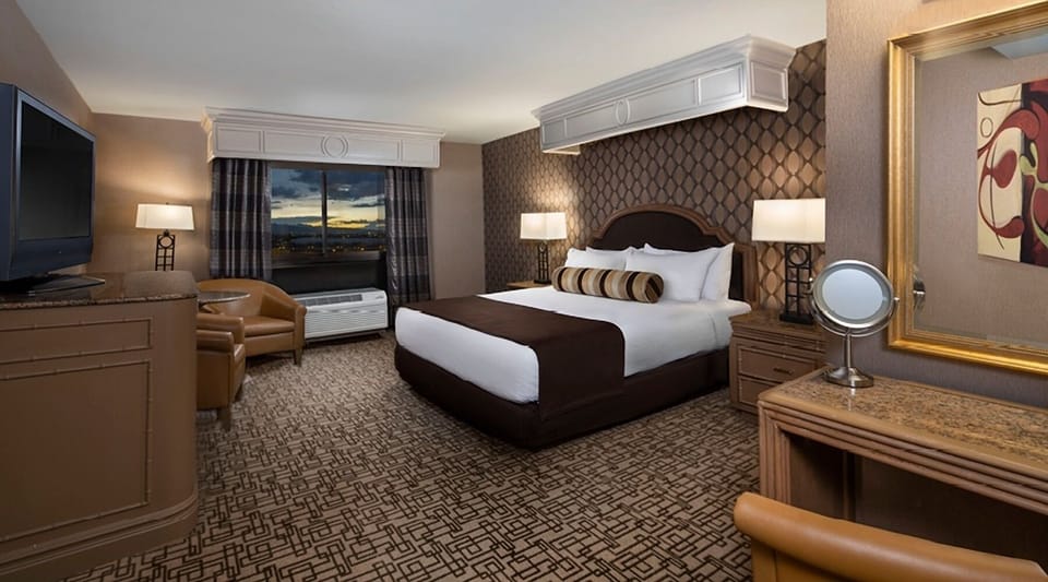 Sink into plush bedding and relax with evening city views.