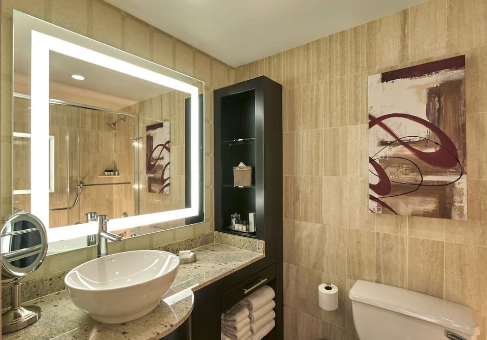 Start your day in a sleek bathroom with glass shower.