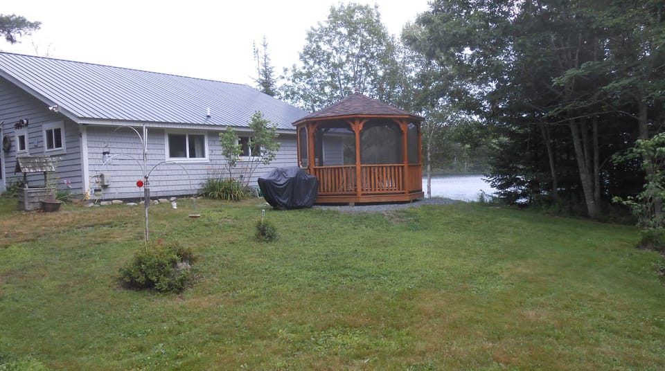 screened gazebo w/ ramp & el. string lights; gas grill. charcoal grill available