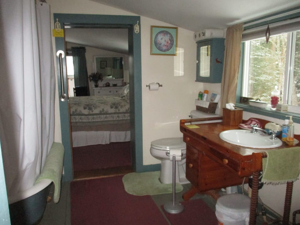 connecting bath room- sliding pocket doors; tub/shower, toilet, sink, shades
