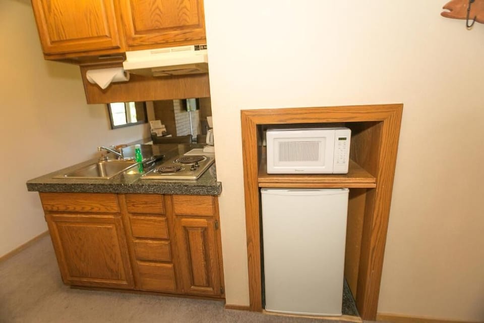 Grab snacks anytime with convenient mini-fridge and microwave setup.