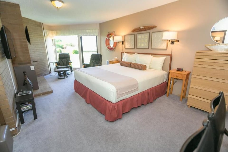 Unwind in a sunlit king bed retreat with cozy seating.