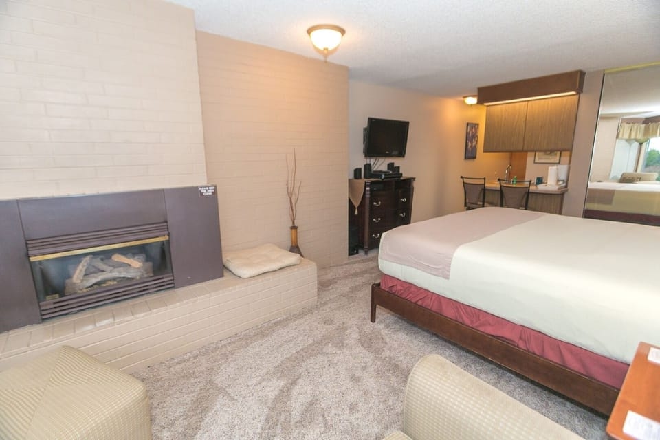 Relax beside the fireplace in this inviting, open bedroom.