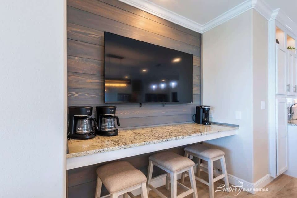TV over coffee bar by kitchen
