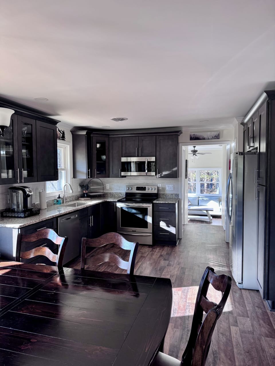 Dining table and kitchen with sunroom in the far back