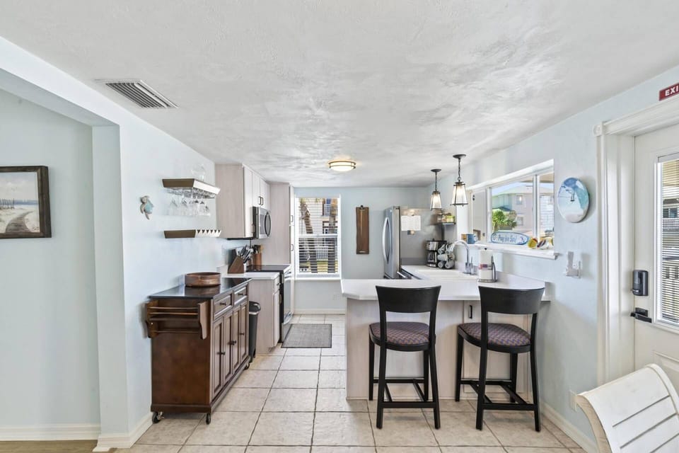 The fully equipped kitchen at Sea Legs Charming Beachfront Cottage is perfect for preparing meals during your coastal getaway.