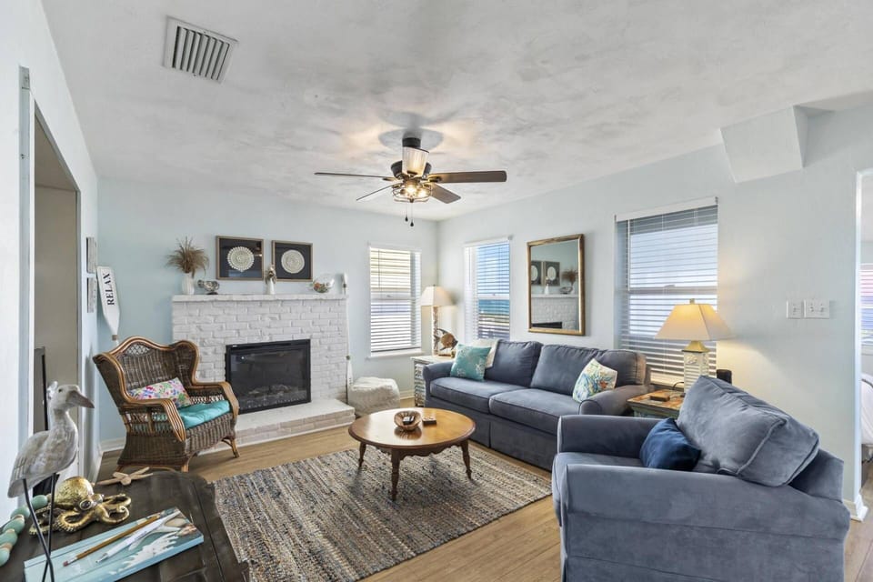 Relax in the inviting living room of Sea Legs Charming Beachfront Cottage. This cozy space is perfect for unwinding after a day of beach fun.
