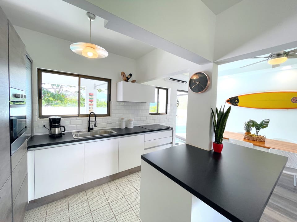 Fully equipped Tamarindo kitchen with modern appliances and ample counter space, ideal for preparing meals during your vacation stay.
