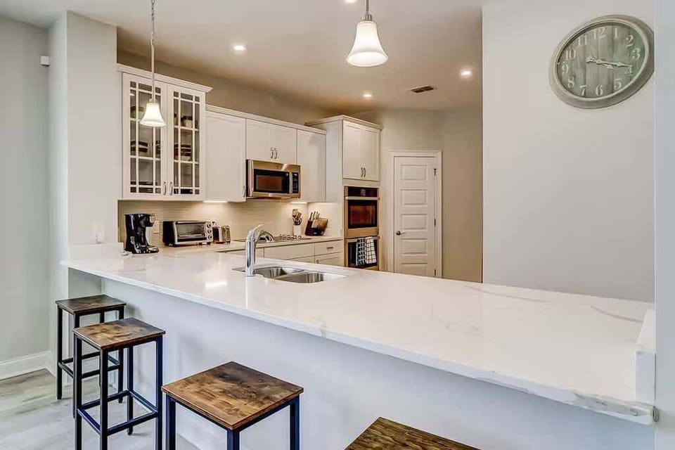 A large island serves as both a prep space and a breakfast bar.