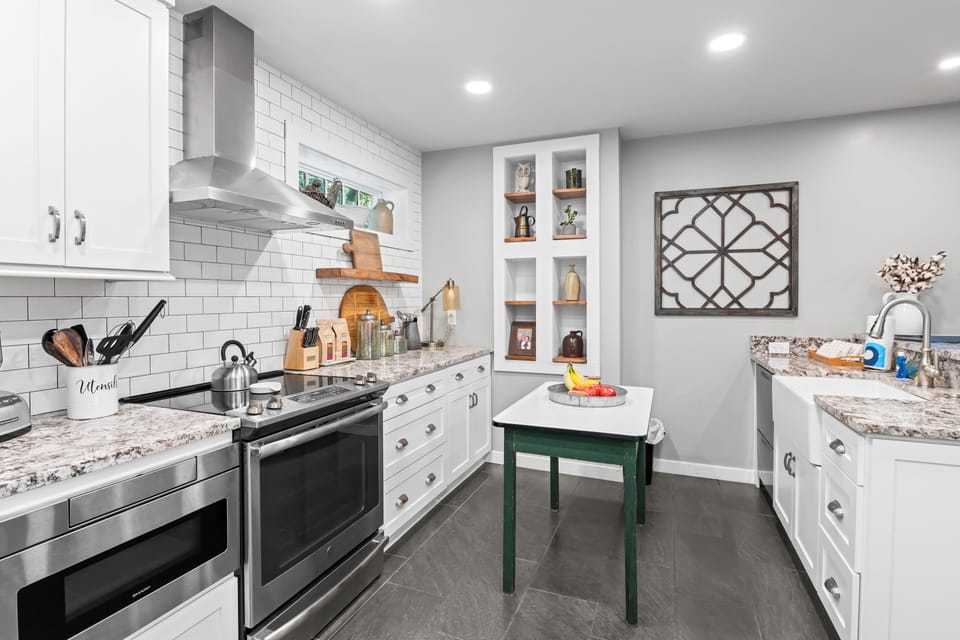 Kitchen includes oven, stove, toaster, and microwave. 