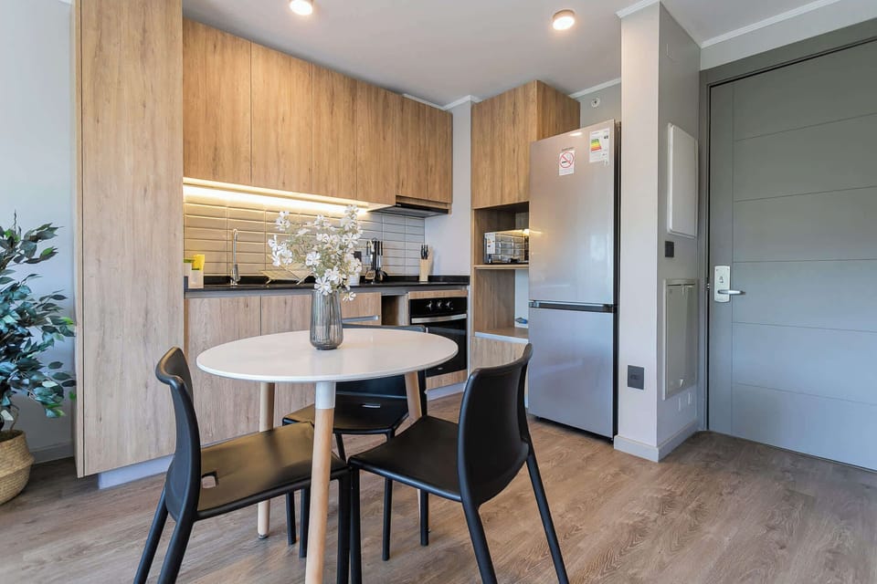 Sleek and modern kitchen with stylish dining area, perfect for cozy meals and culinary adventures.