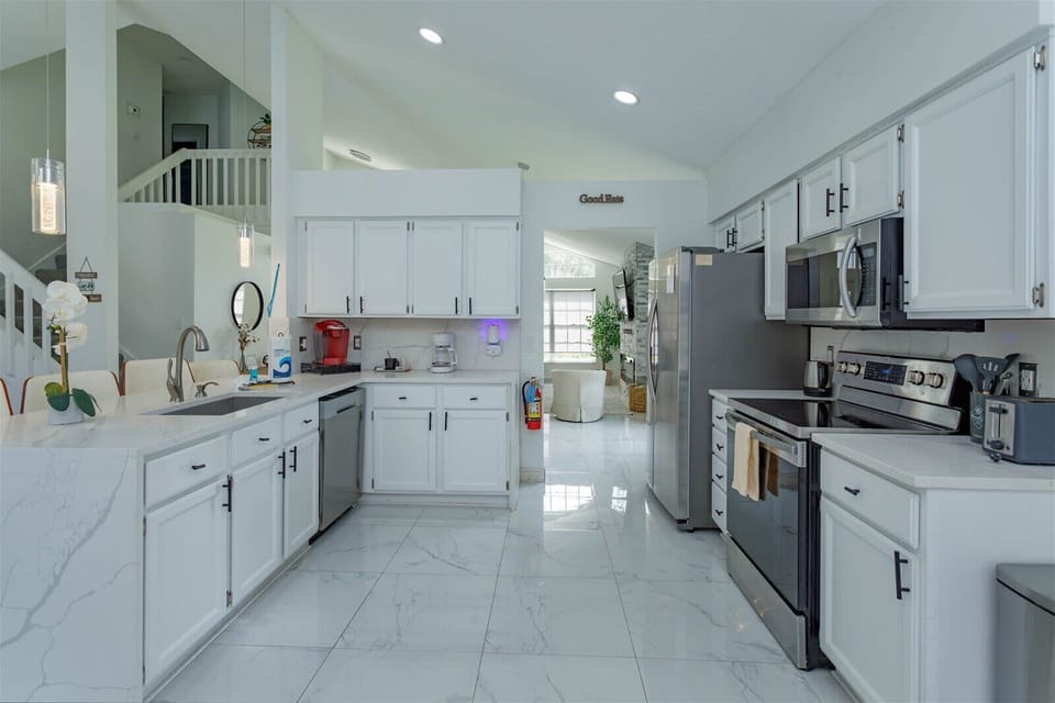 Cook your favorite meals with ease in a kitchen featuring stainless-steel appliances and sleek countertops.