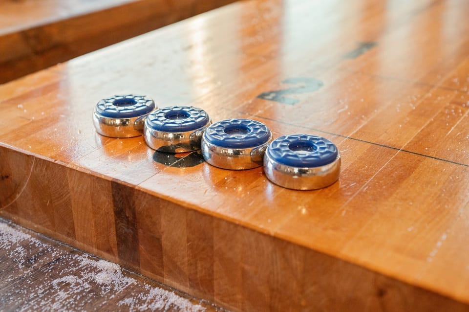 Let the Games Begin
Close-up of the shuffleboard pucks, ready for a friendly match in the game room.