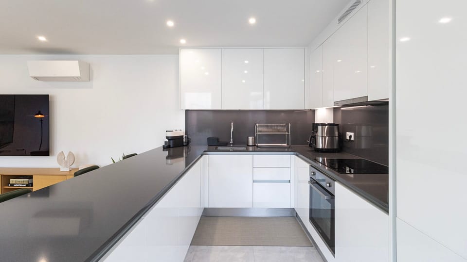 Sleek and modern kitchen with high-gloss cabinetry, black stone countertops, and premium appliances—perfect for cooking or entertaining.
#ModernKitchen #OpenConcept #LuxuryLiving