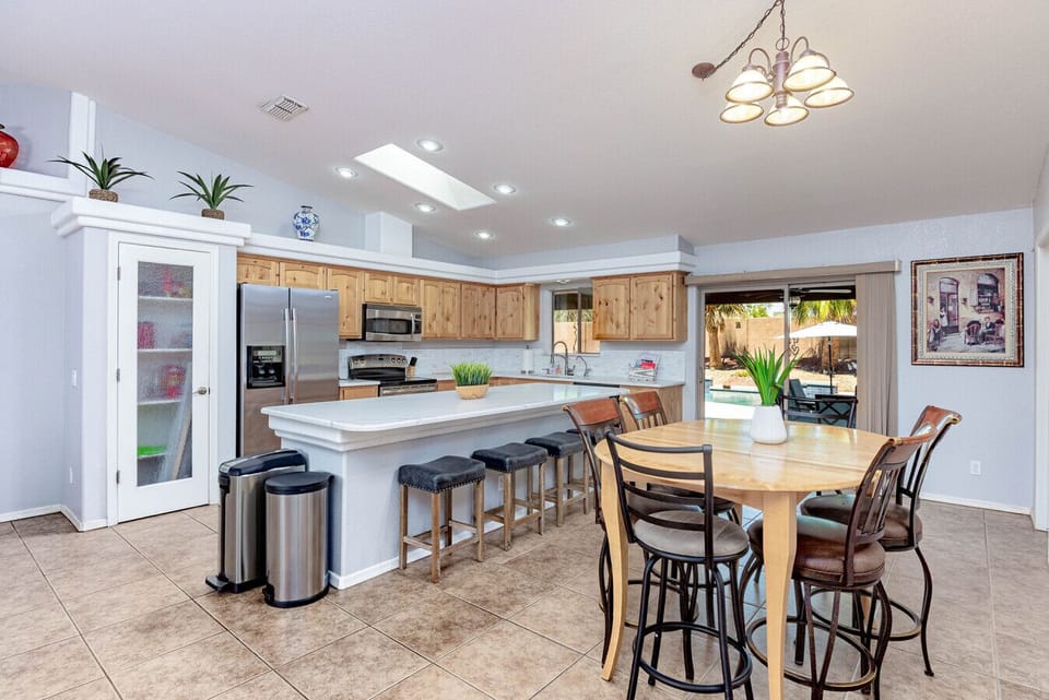 Fully equipped kitchen with modern appliances and breakfast bar seating.