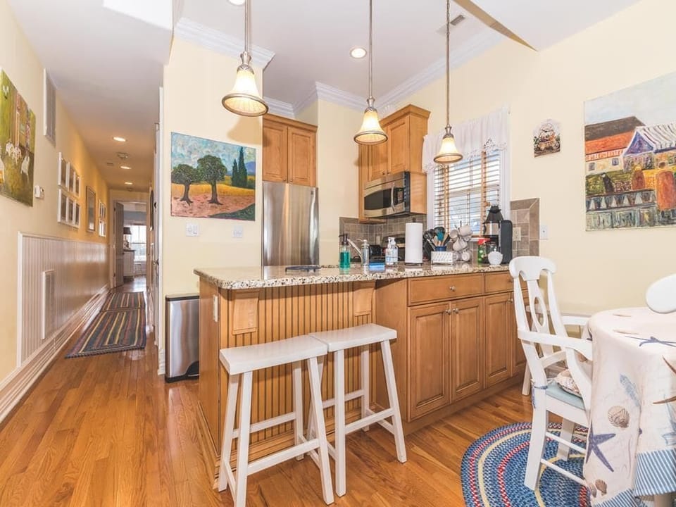 A closer look at the kitchen with a breakfast bar and modern appliances.