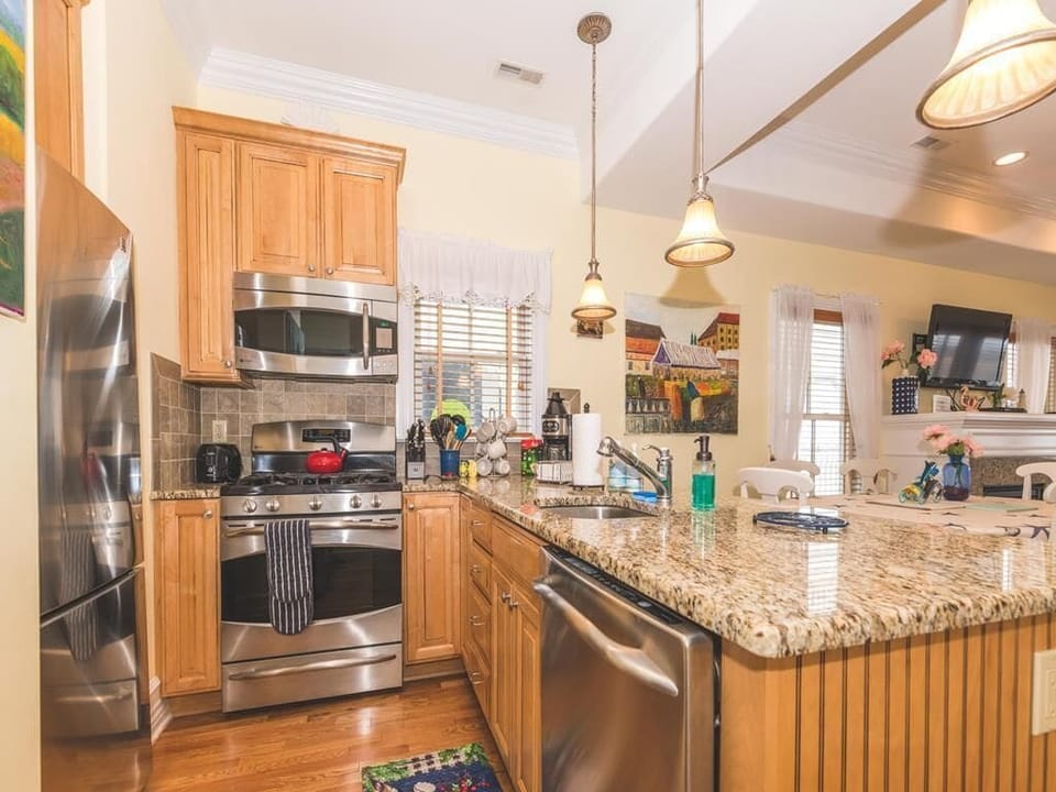 Fully equipped kitchen with granite countertops and stainless steel appliances.