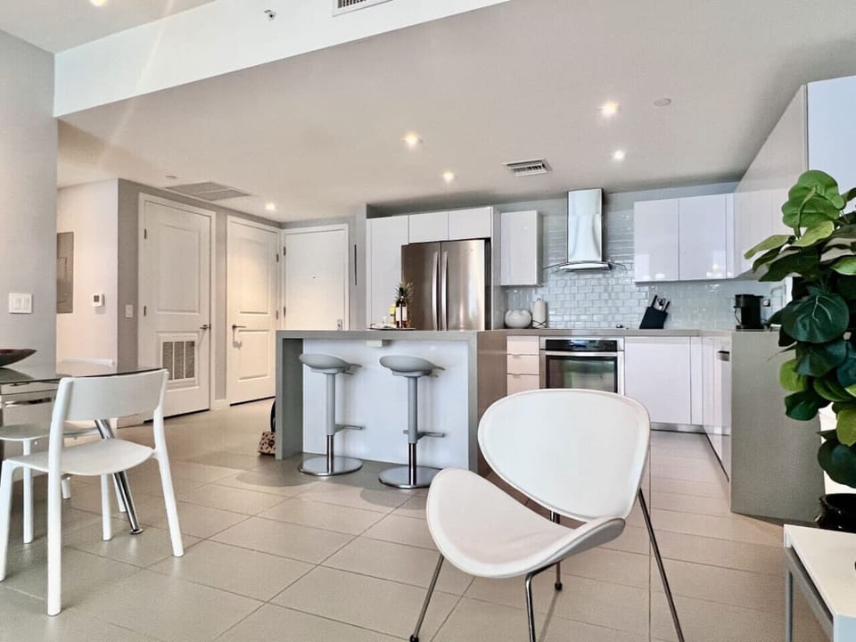 Sleek, modern kitchen with open-plan dining area.