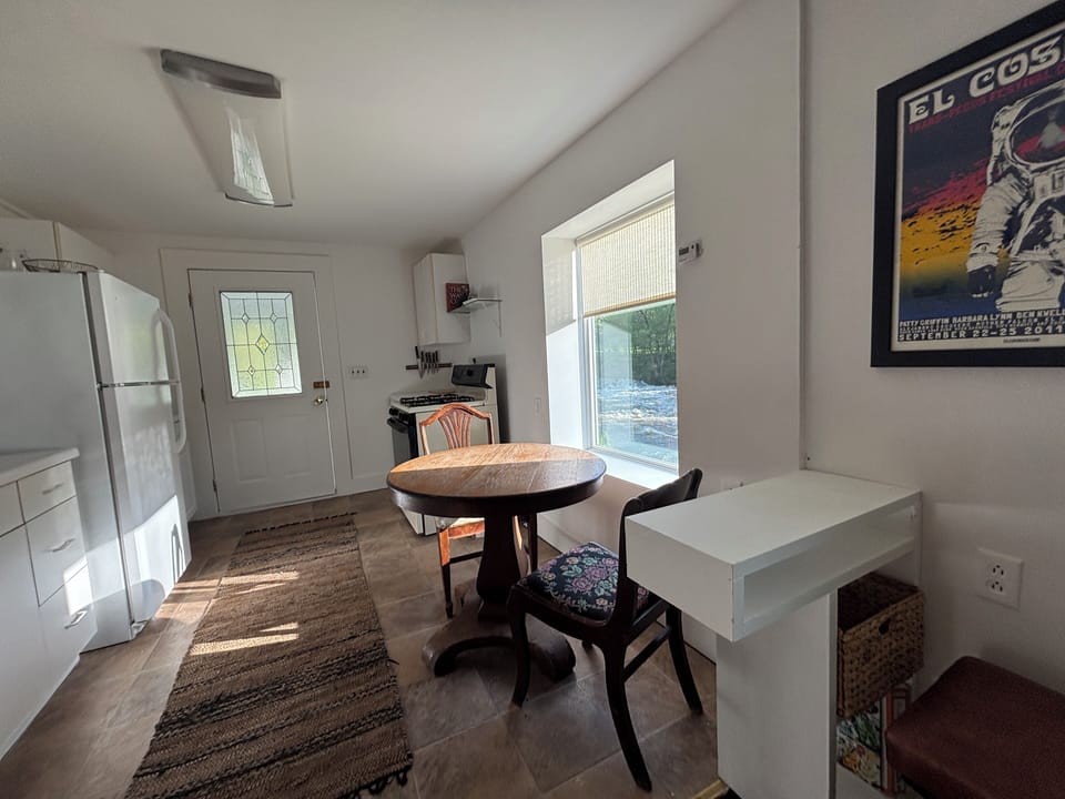 Computer and charging station with a stool and plug in.