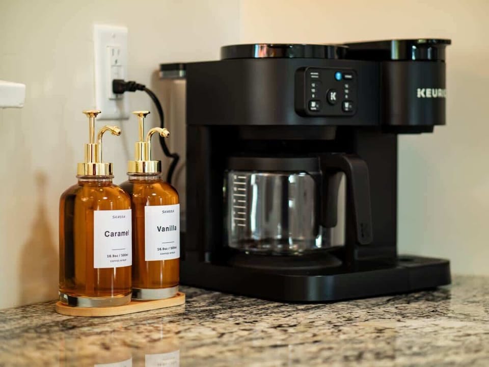 Coffee station w/ drip machine & mugs ready for a fresh morning brew
