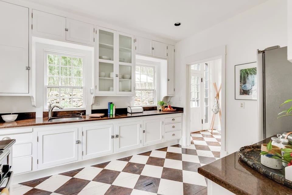 Whip up culinary delights in this beautiful, sunlit space with chic cabinetry!