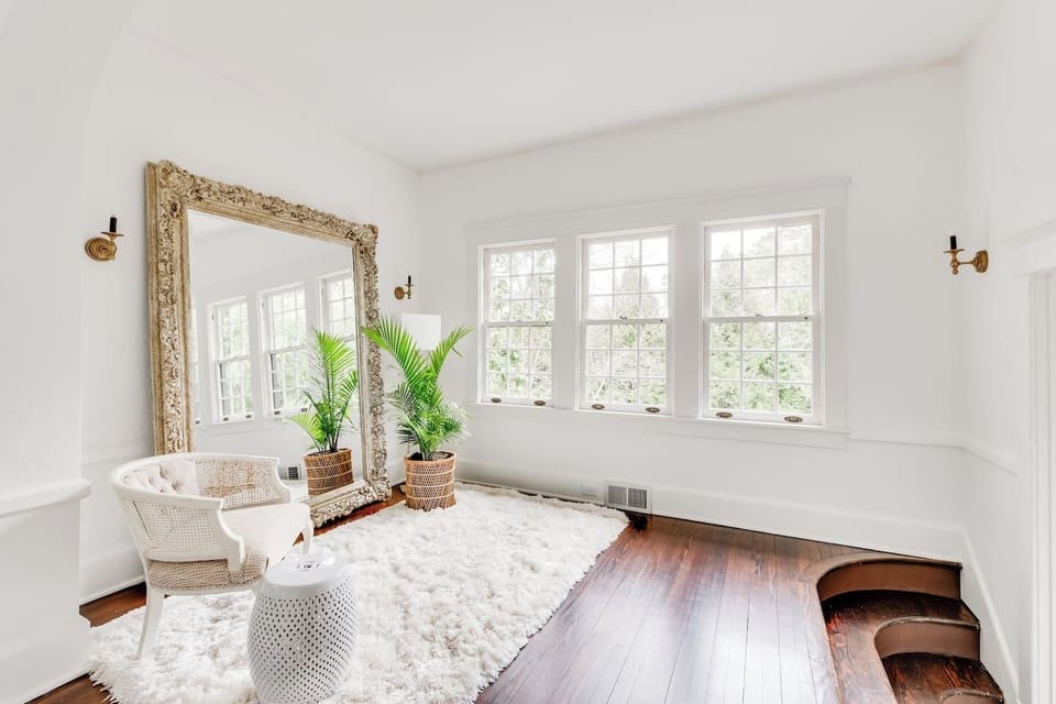 Sunlit Sitting Room: Relax in style surrounded by lush greenery and elegant decor!