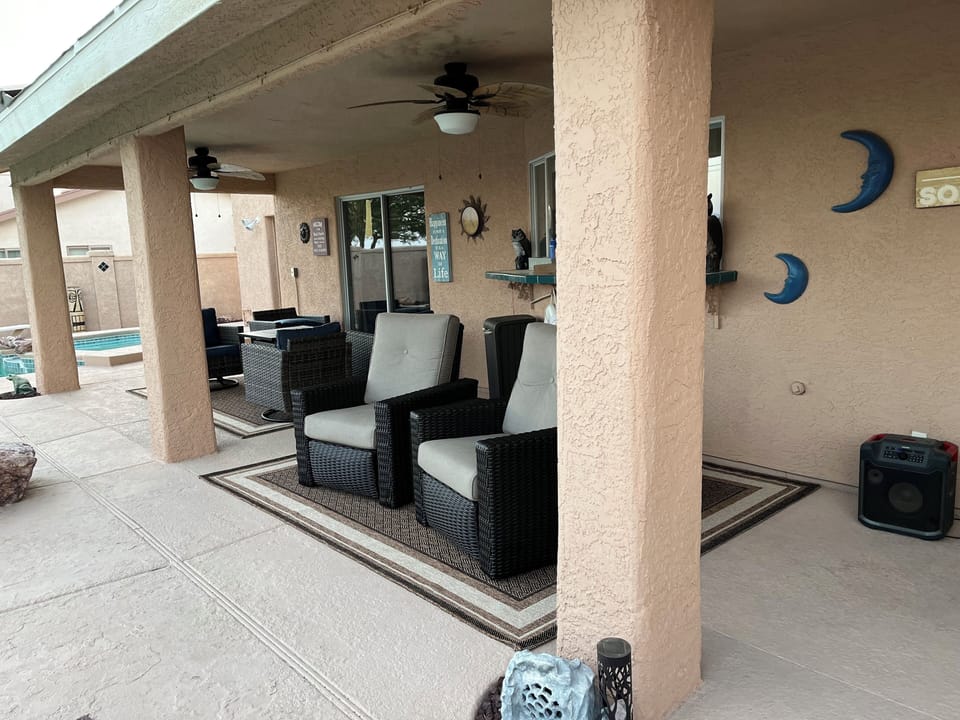 poolside patio with misters, recliners, and swivel rockers