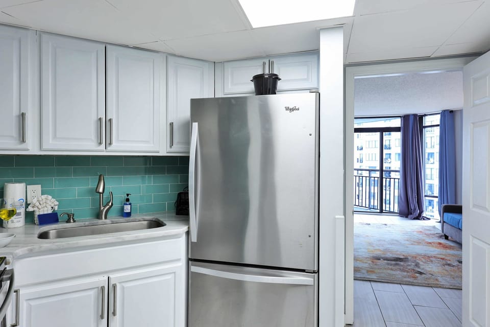 Enjoy the convenience of a sleek, fully stocked kitchen with stainless steel appliances and a fresh coastal vibe—perfect for prepping beach snacks or a cozy dinner in!
