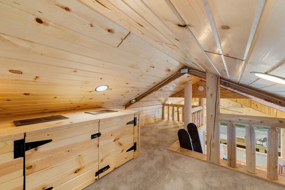 Upper-level view highlighting open railings & vaulted ceilings.