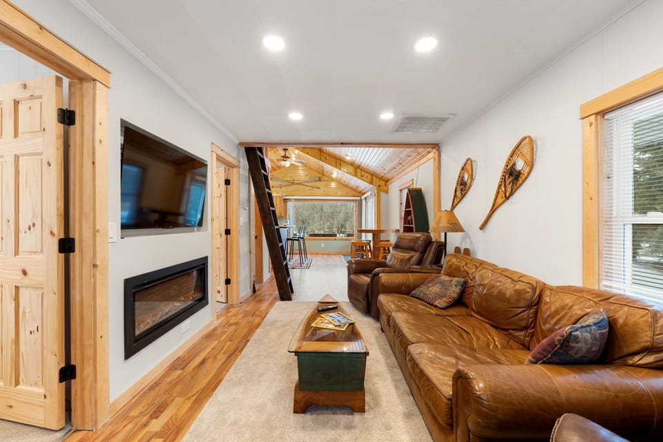 Another angle of the cozy living room, bright & welcoming.