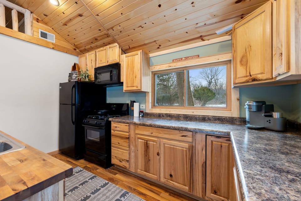 Thoughtful kitchen design w/ modern appliances & wood accents.