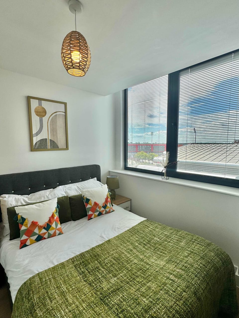 Bright and airy bedroom with plush bedding and a cosy throw so you can unwind after a day exploring Manchester